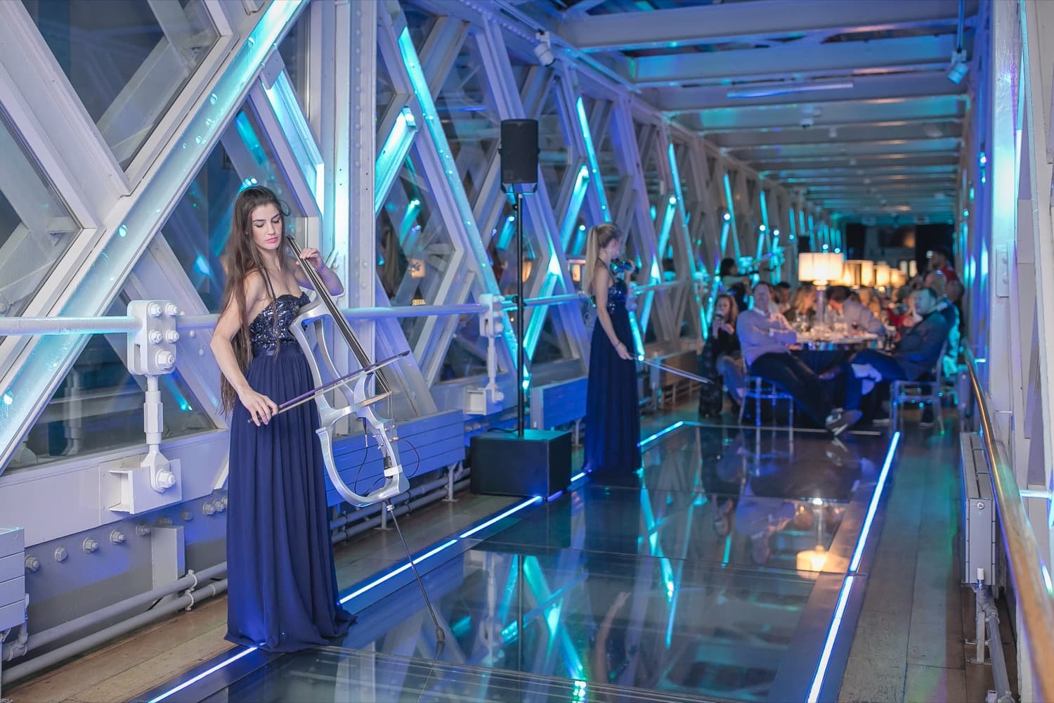 A live performance during an evening event in a modern glass venue